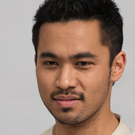 Joyful asian young-adult male with short  black hair and brown eyes