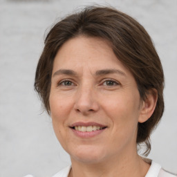 Joyful white adult female with medium  brown hair and brown eyes