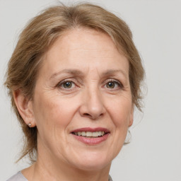 Joyful white middle-aged female with medium  brown hair and blue eyes