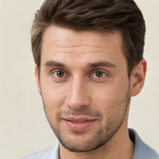 Joyful white young-adult male with short  brown hair and brown eyes