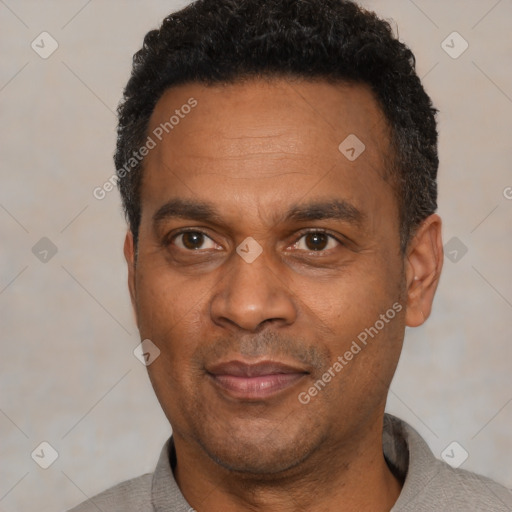 Joyful latino adult male with short  black hair and brown eyes