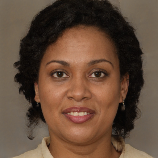 Joyful black adult female with short  brown hair and brown eyes