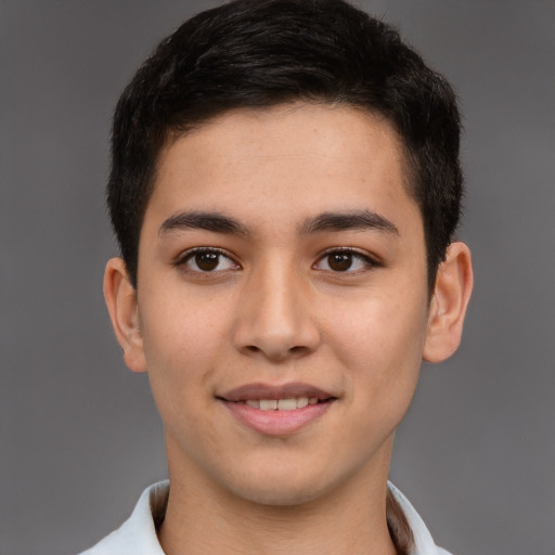 Joyful latino young-adult male with short  brown hair and brown eyes