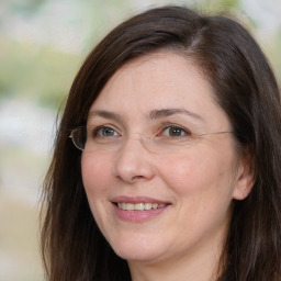 Joyful white adult female with medium  brown hair and brown eyes