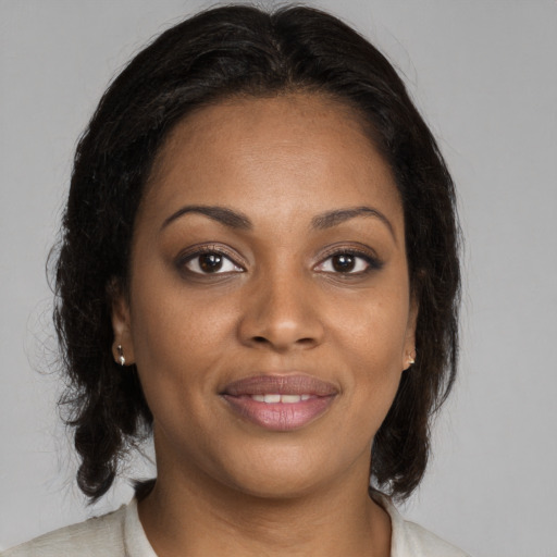Joyful black young-adult female with medium  brown hair and brown eyes