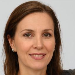 Joyful white adult female with long  brown hair and green eyes