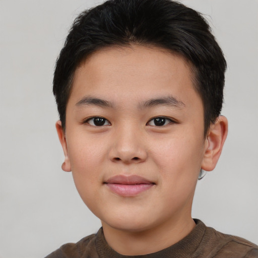 Joyful asian child male with short  brown hair and brown eyes