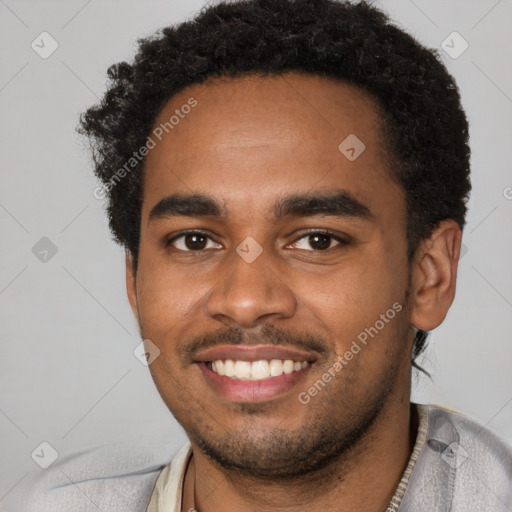 Joyful black young-adult male with short  brown hair and brown eyes