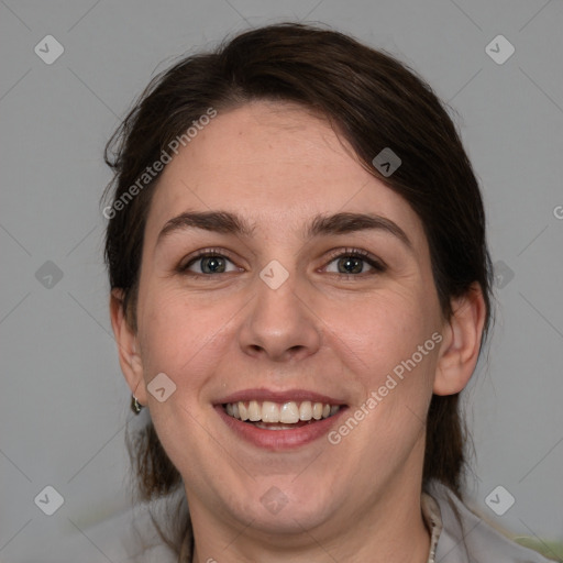 Joyful white young-adult female with medium  brown hair and grey eyes