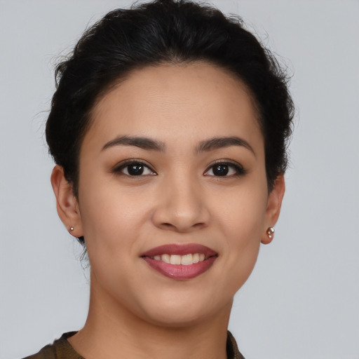 Joyful latino young-adult female with short  brown hair and brown eyes