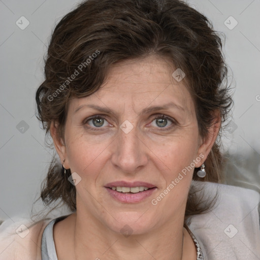 Joyful white adult female with medium  brown hair and blue eyes