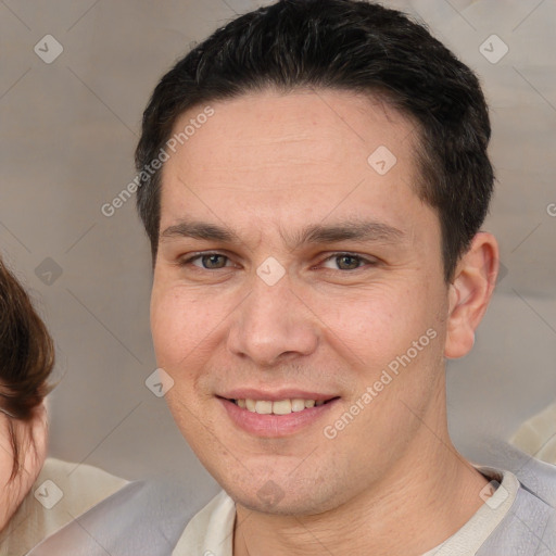 Joyful white adult male with short  brown hair and brown eyes