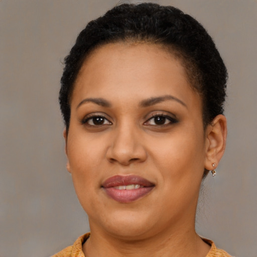 Joyful black young-adult female with short  brown hair and brown eyes