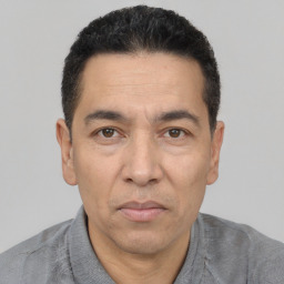 Joyful white adult male with short  black hair and brown eyes