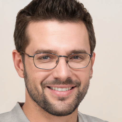 Joyful white young-adult male with short  brown hair and grey eyes