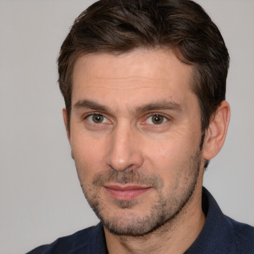 Joyful white adult male with short  brown hair and brown eyes