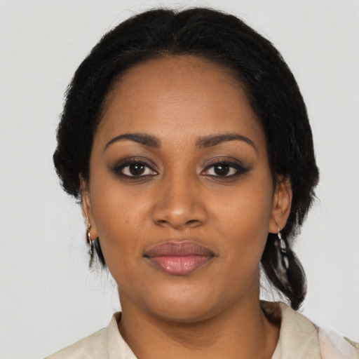 Joyful black young-adult female with medium  black hair and brown eyes