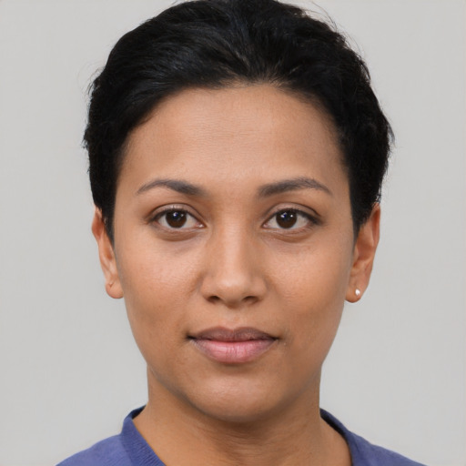 Joyful latino young-adult female with short  black hair and brown eyes