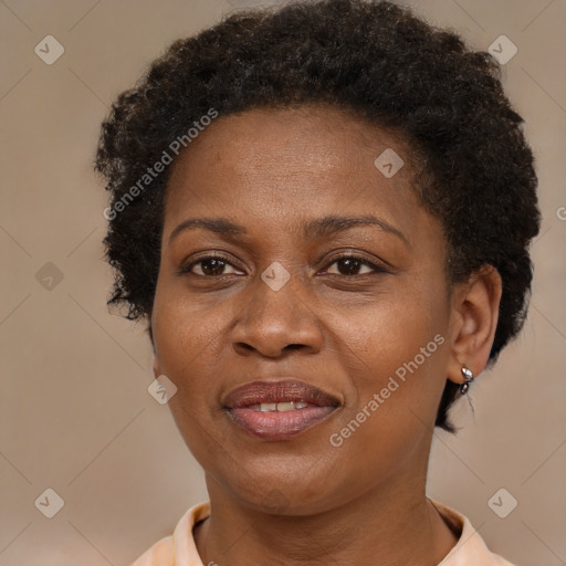 Joyful black adult female with short  brown hair and brown eyes