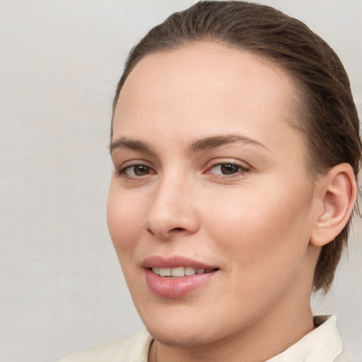 Joyful white young-adult female with medium  brown hair and brown eyes