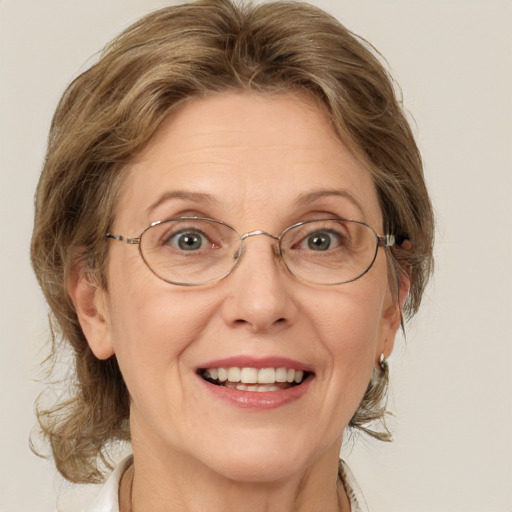 Joyful white middle-aged female with medium  brown hair and blue eyes