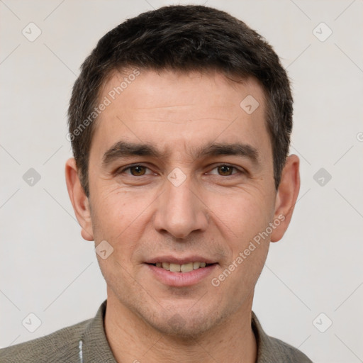 Joyful white adult male with short  black hair and brown eyes