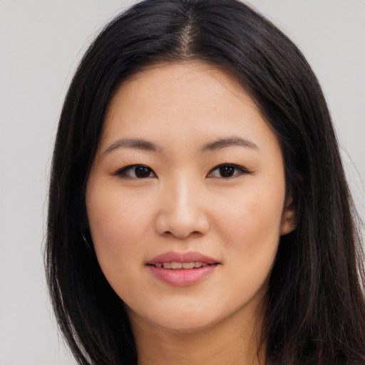 Joyful asian young-adult female with long  brown hair and brown eyes