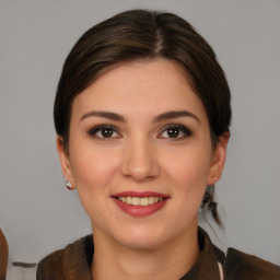 Joyful white young-adult female with medium  brown hair and brown eyes