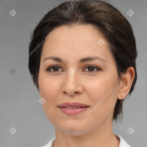 Joyful white adult female with medium  brown hair and brown eyes