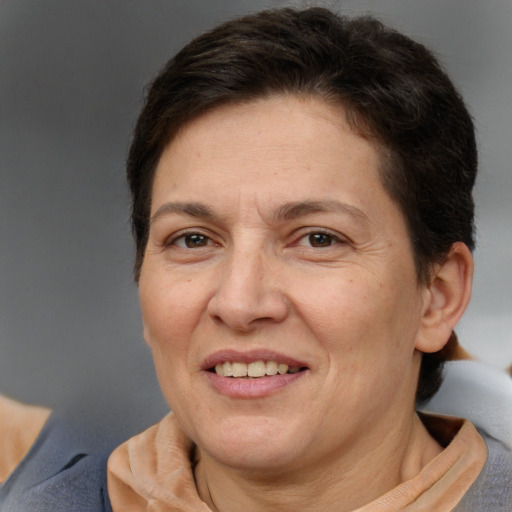 Joyful white adult female with short  brown hair and brown eyes