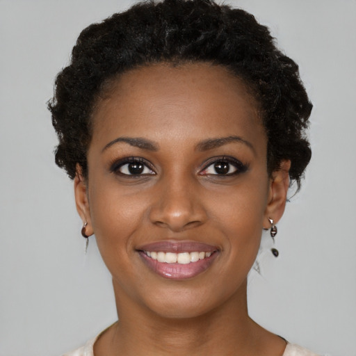 Joyful black young-adult female with short  brown hair and brown eyes