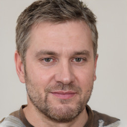 Joyful white adult male with short  brown hair and grey eyes