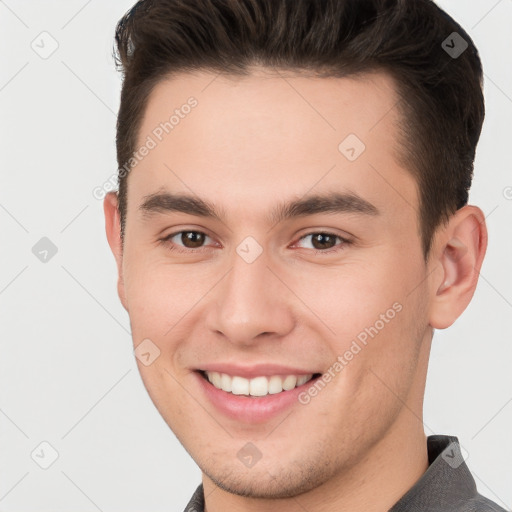 Joyful white young-adult male with short  brown hair and brown eyes