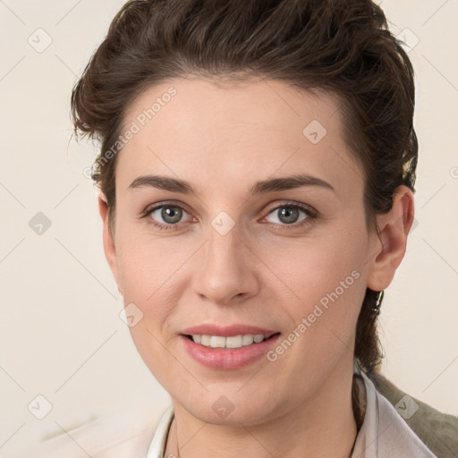 Joyful white young-adult female with medium  brown hair and grey eyes