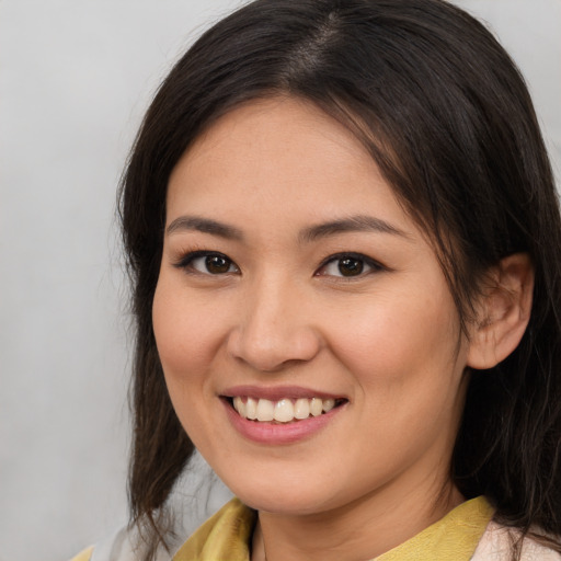 Joyful asian young-adult female with medium  brown hair and brown eyes