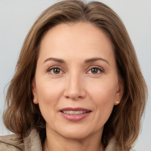 Joyful white adult female with medium  brown hair and brown eyes