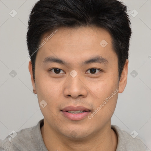 Joyful asian young-adult male with short  brown hair and brown eyes