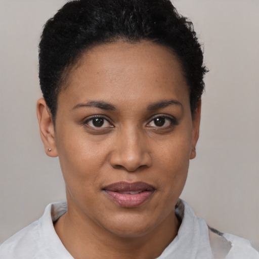 Joyful black young-adult female with short  black hair and brown eyes