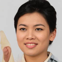 Joyful asian young-adult female with medium  brown hair and brown eyes