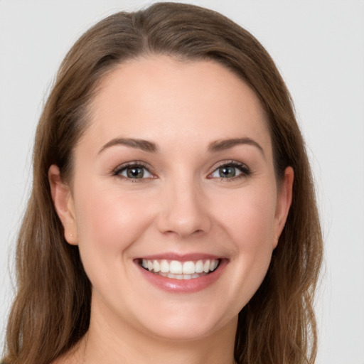 Joyful white young-adult female with long  brown hair and grey eyes