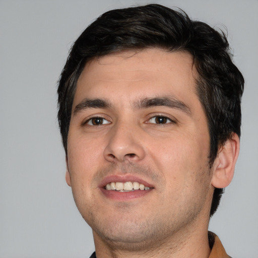 Joyful white young-adult male with short  black hair and brown eyes