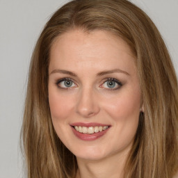 Joyful white young-adult female with long  brown hair and brown eyes