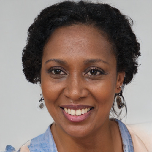 Joyful black adult female with short  brown hair and brown eyes