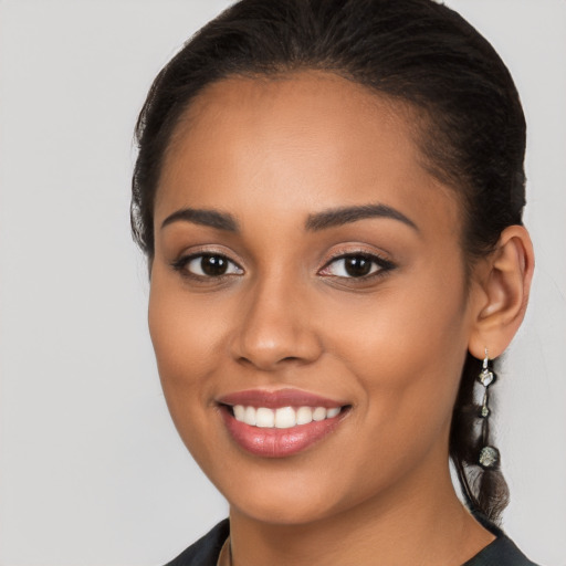 Joyful latino young-adult female with long  brown hair and brown eyes