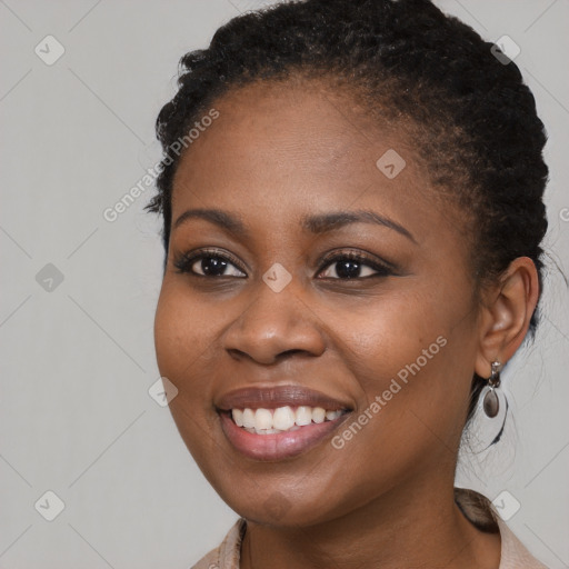 Joyful black young-adult female with long  brown hair and brown eyes