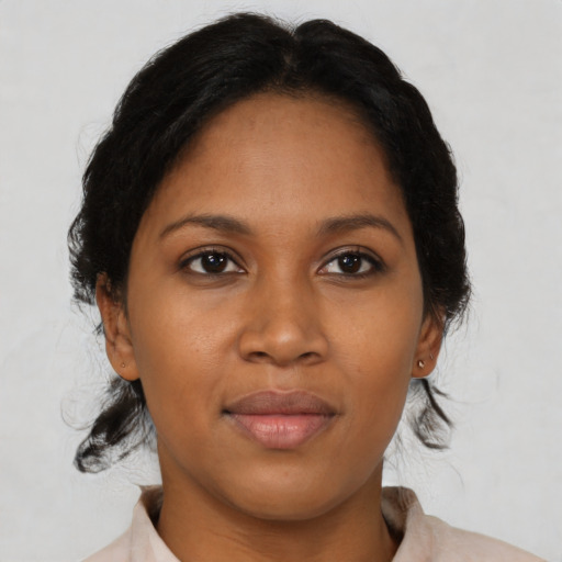 Joyful latino young-adult female with medium  brown hair and brown eyes