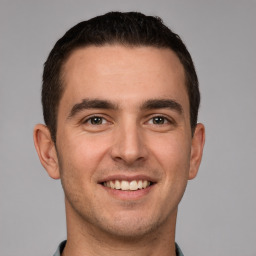 Joyful white young-adult male with short  brown hair and brown eyes