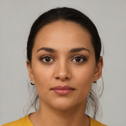 Joyful latino young-adult female with short  brown hair and brown eyes