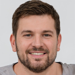 Joyful white young-adult male with short  brown hair and brown eyes