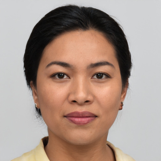 Joyful asian young-adult female with medium  brown hair and brown eyes